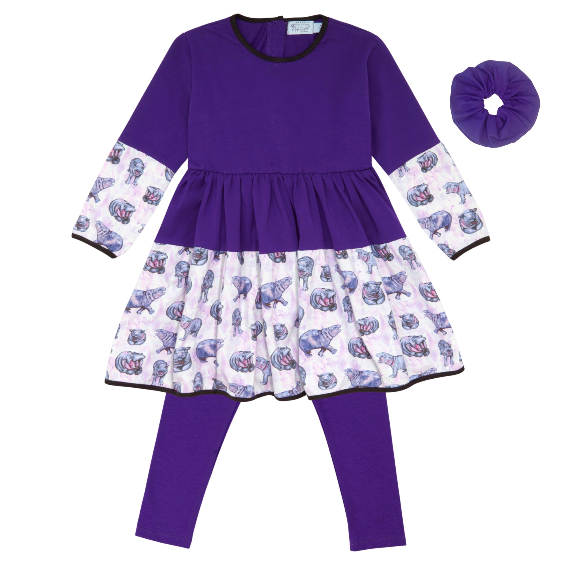 Purple dress with patterned sleeves and leggings, accompanied by a matching scrunchie on a white background.