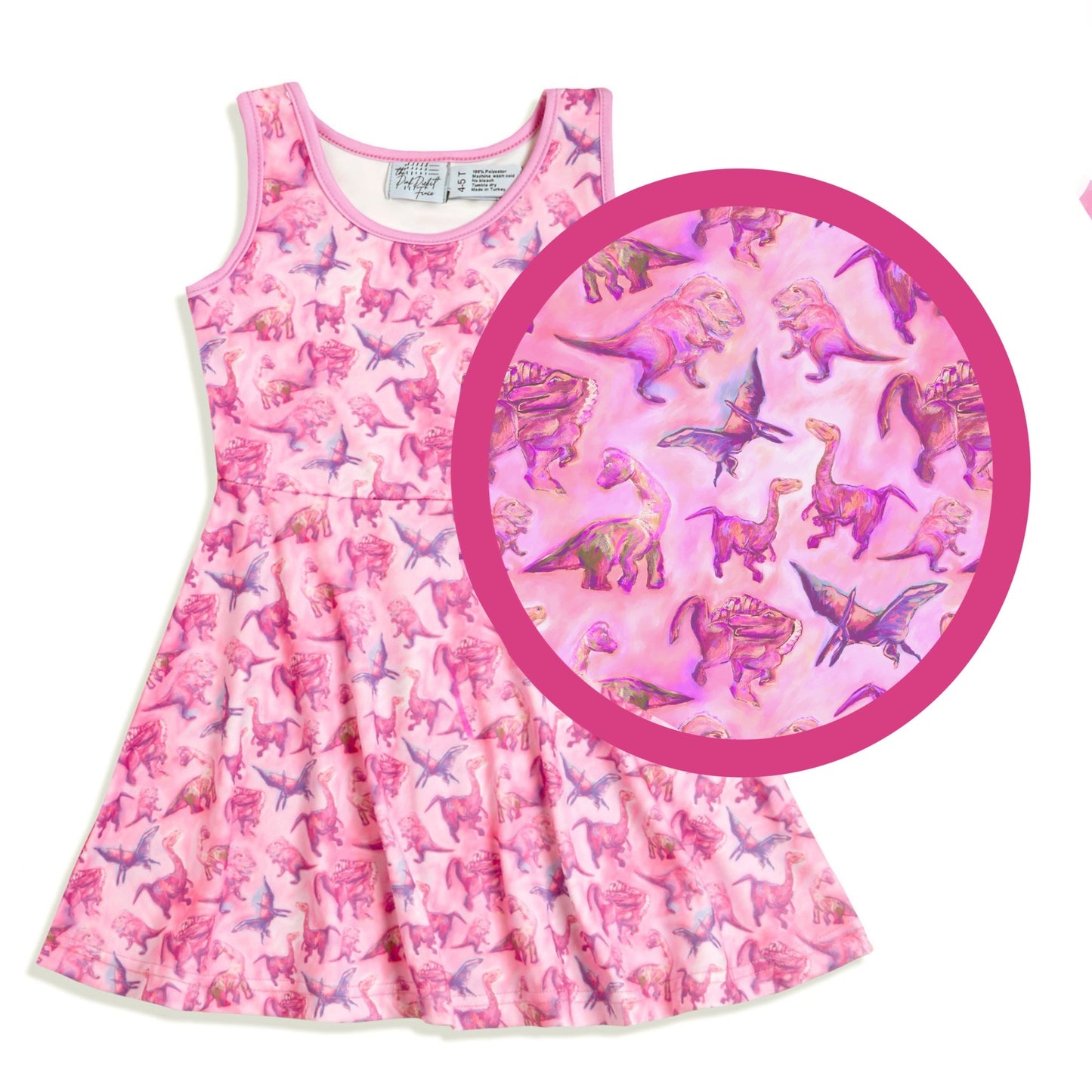 close up of pink dinosaur print on girls twirl dress soft sensory friendly fabric